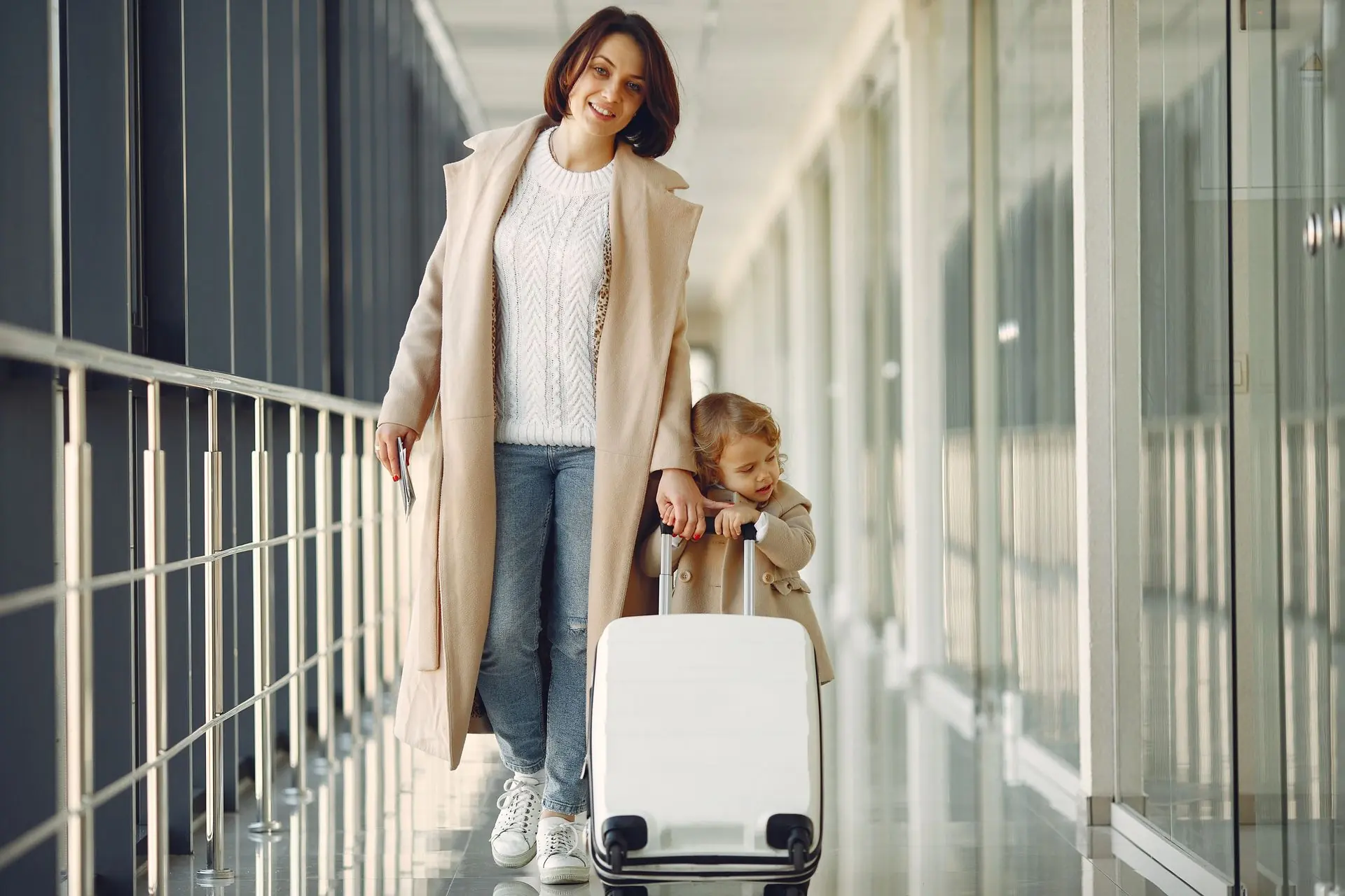 Mother and daughter traveling together through an airport